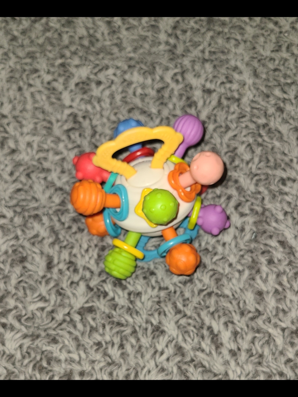 Nuby Textured Twist Ball Baby Teether Toy with Colorful Rattle
